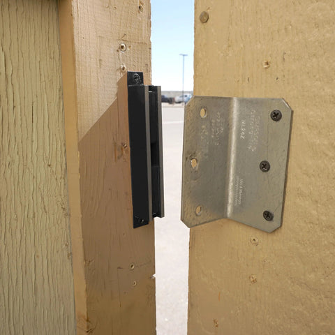 AM3 RM100C Magnet Catch Industrial Type with mounting holes, black finish installed on wooden door for heavy-duty enclosures