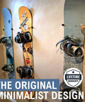 Three snowboards displayed on a wall using a Minimalist Snowboard Wall Mount Display Rack Featuring Felt Padded Arms And Durable Rubber Grip