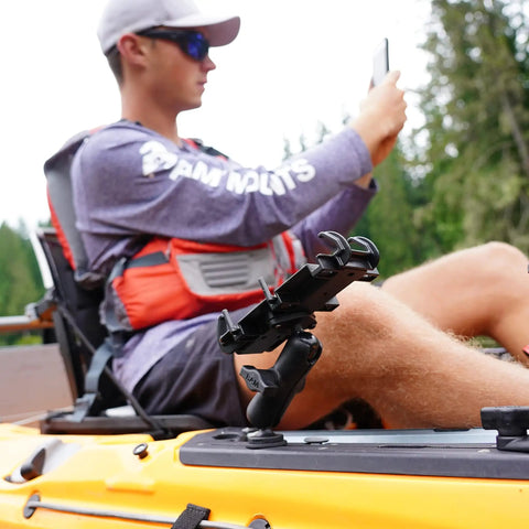 Medium Double Socket Arm For B Size 1 Inch Ball Components mounted on kayak, holding a smartphone. Adjustable mount in use outdoors.
