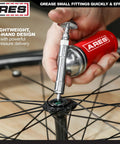 Close-up of ARES 53010 3-Ounce push-type mini grease gun with needle nozzle greasing bicycle wheel hub