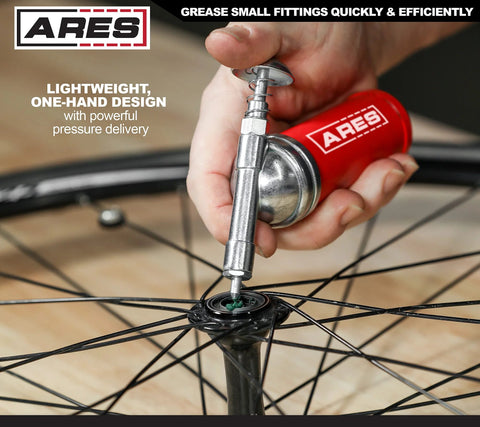 Close-up of ARES 53010 3-Ounce push-type mini grease gun with needle nozzle greasing bicycle wheel hub