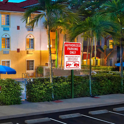 Authorized Parking Only Sign 2 Pack Towed At Owners Expense Warning Plate 14 By 10 Inch Heavy Duty Aluminum Outdoor Marker in a parking lot.