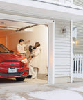 People using Tesla NACS Level 2 EV Charger With 48 Amp Fast Charge 11.5kW in a snowy garage setting