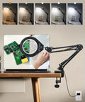 Hands Free Desk Magnifier With Light 10X And 5X Real Glass Anti Glare Lens, adjustable arm, fixed on a wooden desk.