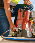 Tough As Nails 18V Cordless Airless Paint Sprayer With Advanced HEA Tech connected to hose on job site for efficient painting.