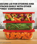 Three stacked Big 11 Cup Glass Food Storage Container With Snug BPA Free Lid For Leftovers And Meal Prep filled with vegetables