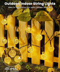 Outdoor Waterproof Solar String Lights 2 Pack, 72 Ft Total, 120 LEDs, 8 Lighting Modes illuminating a garden fence.