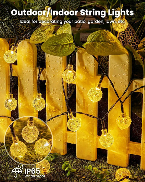 Outdoor Waterproof Solar String Lights 2 Pack, 72 Ft Total, 120 LEDs, 8 Lighting Modes illuminating a garden fence.