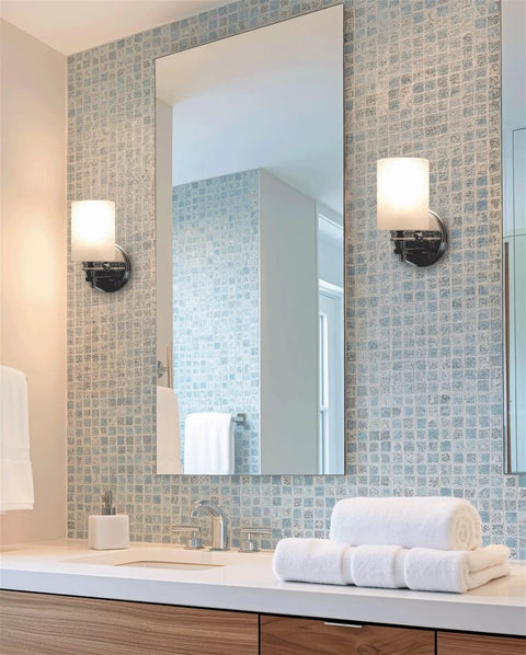 Kira Home Phoebe 8" Modern Industrial Wall Sconce for Bathroom Vanity, Pack of 2 mounted beside a bathroom mirror.