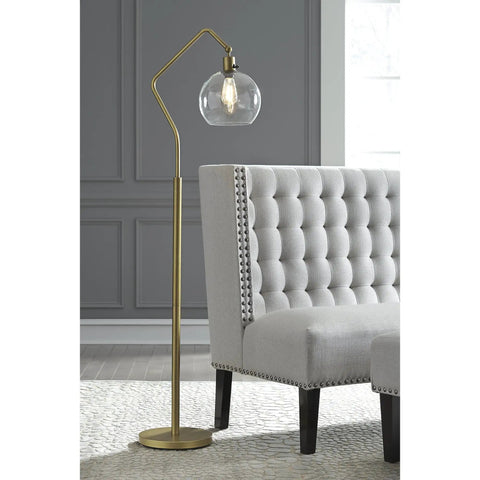Modern Floor Lamp With Glass Shade And Angular Arm In Antique Brass, 61 Inch Tall next to gray button-tufted furniture