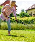 Person using Multi Functional Manure Fork For Lawn Care And Farm Use A Rugged Heavy Duty Pitch Fork For Clearing Debris And Manure.