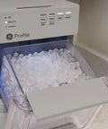 Legit Nugget Ice Maker showing soft chewable ice in the 2-pound storage bin, countertop design, stone grey finish.