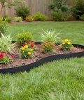 100 Ft No-Dig Garden Edging 2 Inch Flexible Landscape Border DIY Friendly Heavy Duty Plastic Lawn Edge with 150 Stakes Weed Barrier Border for Yard Flower Beds Patios and Playgrounds surrounding flower bed with vibrant plants.