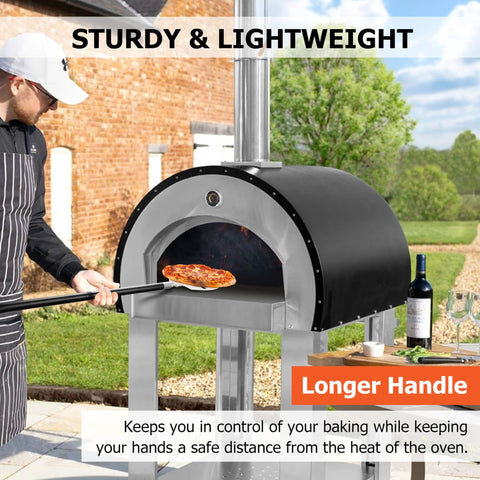 Pizza oven in backyard, stainless steel body with a long-handled pizza peel sliding a pizza inside.