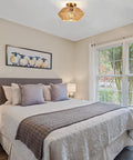 Boho Woven Rattan Ceiling Light Fixture With Handwoven Cage, Semi Flush Mount, in a cozy bedroom with rustic decor.