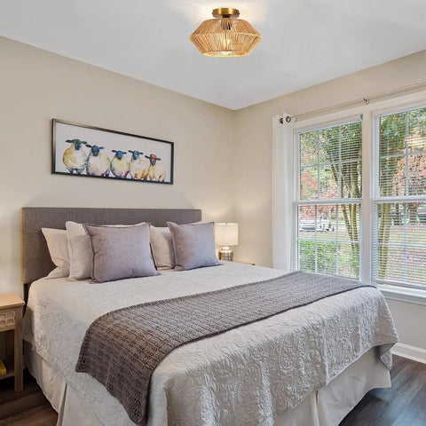 Boho Woven Rattan Ceiling Light Fixture With Handwoven Cage, Semi Flush Mount, in a cozy bedroom with rustic decor.