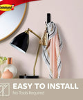 Damage Free Wall Hanger Set With Adhesive Strips Matte Black Double Hooks holding scarf near lamp and mirror