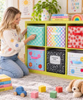 Woman organizing 6 Piece Slick Fabric Storage Bins 11 Inch vibrant cubby basket organizers with grippy handles for classrooms and nurseries.