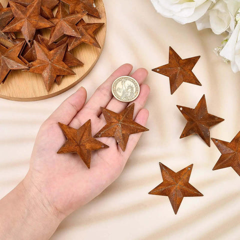 Person holding Rusty Barn Star Set Thirty Pieces Two Inch Metal Stars For Crafts Rustic Primitive Accents