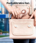Mini Portable Handheld Fan With Base 3 Speed USB Rechargeable in pink bag, lightweight quiet design.