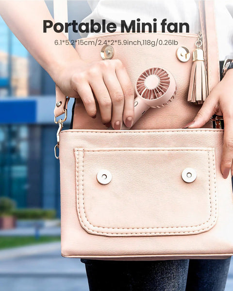 Mini Portable Handheld Fan With Base 3 Speed USB Rechargeable in pink bag, lightweight quiet design.