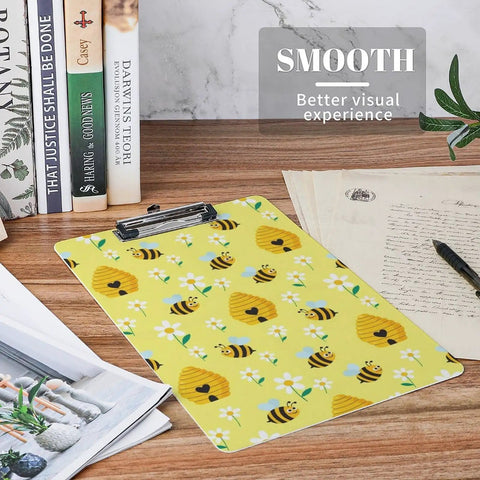 Honey Bee Print Sturdy Acrylic Clipboard For A4 Papers, Clear Desk Organizer With Smooth Writing Surface, Real Deal Heavy Duty See Through Clipboard For School, Office, Or Home, Fits US Letter And A4. Yellow bee print acrylic clipboard with metal clip on desk.