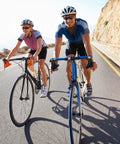 Two cyclists riding on a road with a Portable Inverted Ebike Repair Stand With Handlebar Jacks For Quick On The Go Fixes For Commuters And Cyclists.
