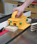 GRR-RIPPER 3D Pushblock With One Eighth Inch Leg used on table saw cutting wood, showing safety grip and yellow design