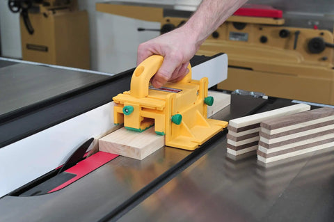 GRR-RIPPER 3D Pushblock With One Eighth Inch Leg used on table saw cutting wood, showing safety grip and yellow design