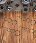Pro Grade 225 Piece Carbon Steel C Shape External Snap Ring Kit for Industrial Shafts on wooden background with gears