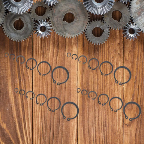 Pro Grade 225 Piece Carbon Steel C Shape External Snap Ring Kit for Industrial Shafts on wooden background with gears
