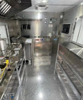 Inside view of Custom Rollout Food Trailer Kitchen Unit Featuring Heavy Duty Refrigerator Commercial Sink And Stainless Steel Juicer Station.