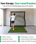 Man practicing with Home Series Golf Training Net 7x7 With Auto Ball Return in garage showing indoor setup possibilities.