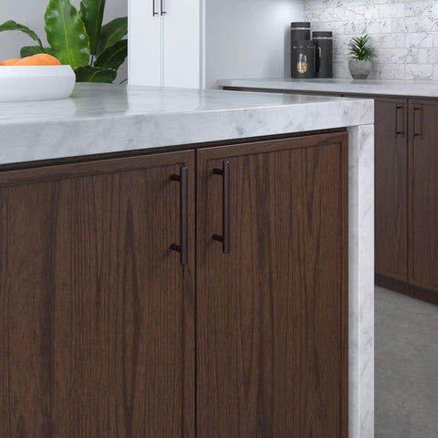Brushed Oil Rubbed Bronze Cabinet Handle Four And A Quarter Inch Center To Center Steel Drawer Pull installed on dark wood cabinet in kitchen