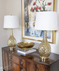 Set of 2 Fletcher Glass Genie Table Lamps in Ombra Gold Mercury Glass With White Lamp Shades displayed on a wooden console