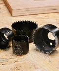 Detail of 13 blades from the Beast Hole Saw Kit With 27 Piece Set Including 13 Blades From Three Quarter Inch To Five Inch Mandrels Hex Key Drill Bits And Storage Case Perfect For Soft Wood And Pvc Boards Great Gift For Diyers And Handymen on wooden surface.