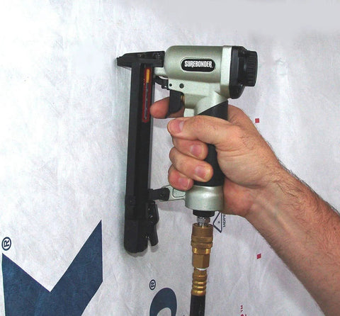 Heavy Duty Pneumatic Staple Gun For Upholstery And Woodworking With Easy Trigger Compatible With T50 And 4 Staples in use on wall