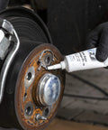 Applying Anti-Seize Assembly Paste, 3.0 Oz, Heat Resistant Lubricant and Corrosion Protection for fasteners on a car brake assembly