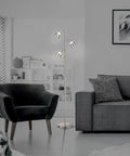 Ash 3-Head LED Tree Floor Lamp With Dimmable Lights in living room, antique brass finish, next to gray couch and black armchair.