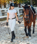 Woman leading horse wearing 1.5 Inch Equestrian Elastic Belt For Women With Snaffle Bit Buckle Adjustable Horseback Riding Belt.