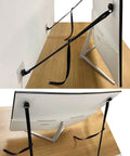 Two Pack Adjustable TV Safety Straps No Drill Adhesive Anti Tip Furniture Anchors securing a flat screen TV to a wall and desk.