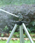 Heavy Duty Impact Sprinkler On Tripod Base With Extra Tall Pulsating Metal Sprinkler For Large Yards And Gardens Telescoping Legs Waters Up To 90 Ft Diameter Durable Tripod System in action.