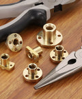 8 Pcs TR8x8 Brass Lead Screw Nut Set With Trapezoidal Acme Thread 2mm Pitch 4 Start 8mm Lead with tools on table.