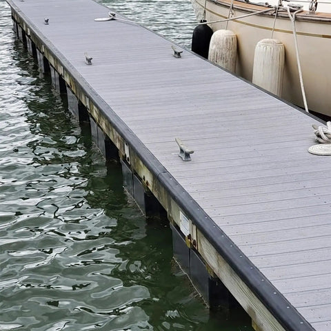 P Profile Dock Bumpers Three Pack Ten Foot Heavy Duty Wall EPDM Rubber Docking Fender installed on a wooden dock by water's edge