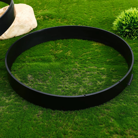 Top view of black round mold on grass, part of Two Round Stepping Stone Molds For Concrete Pavers Reusable Plastic Path Maker Kit