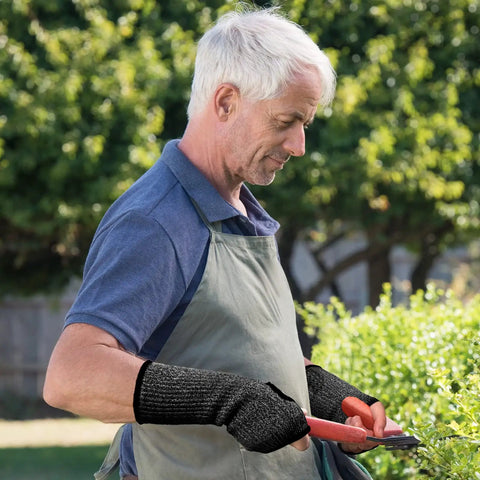 Set Of Three Cut Resistant Arm Sleeves Lightweight Thumb Hole Guards For Yard Work Kitchen Chores Secure Grip Protection Soft Comfort Fit Quick Flip Design No Sweat Daily Carry. Man using arm sleeves while gardening.