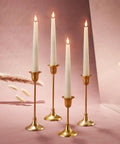Flameless Taper Candle Set 4 Pack 9 Inch Ivory Wax With Realistic 3D Wick Flame Flickering LED Remote Control And Timer Included Battery Powered Home Decor For Winter Holidays And Window Displays Cozy Glow displayed on gold candlesticks