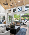 Heavy Duty Extra Long Curtain Rods for Those Huge Windows and Sliding Doors Adjustable From 12 to 20 Feet 1 Inch Thick Metal Brackets Black Drapery Rod for Living Room Patio and Outdoor Spaces visible in a modern living room with large windows and patio doors.