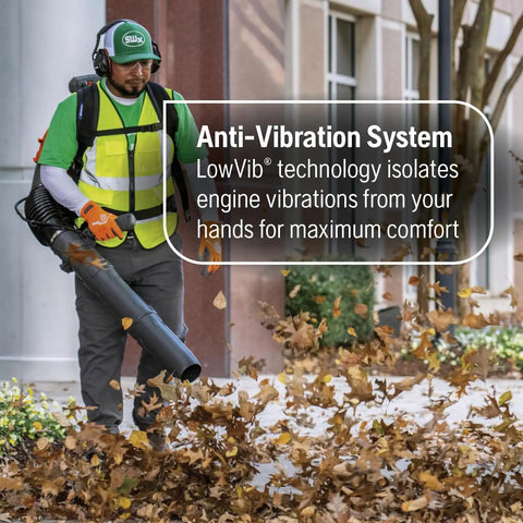 Worker using Beast Gas Backpack Leaf Blower With 75.6cc 4.59-HP 2-Cycle Power, blowing leaves on a sidewalk.