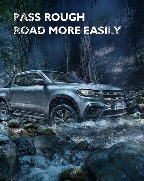 Silver pickup truck driving through rocky stream in forest, highlighting rugged capability